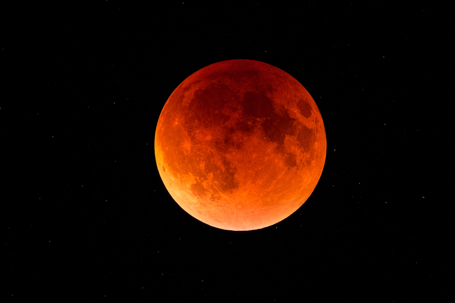 A full moon with a reddish tint during a total lunar eclipse.