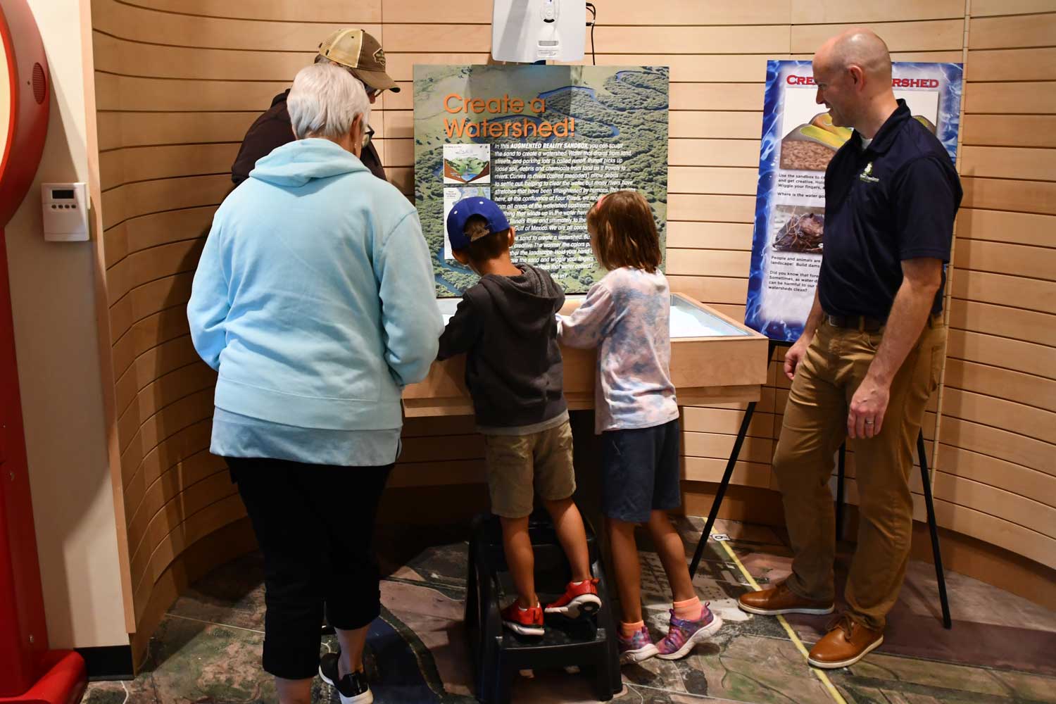 Young children playing with an interactive exhibit