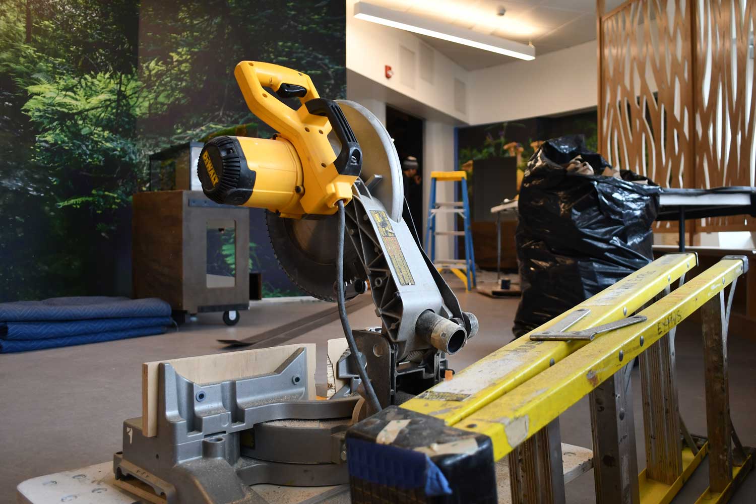 Construction equipment sitting in a room inside a nature center.