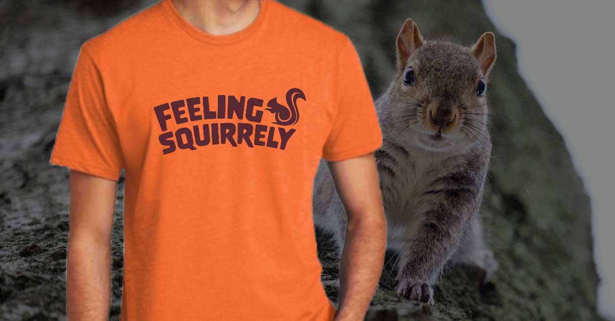 A young man wearing an orange shirt that says feeling squirrely with a squirrel on it