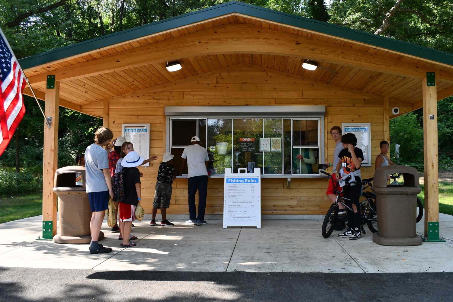 People standing in line waiting at a bait shop.