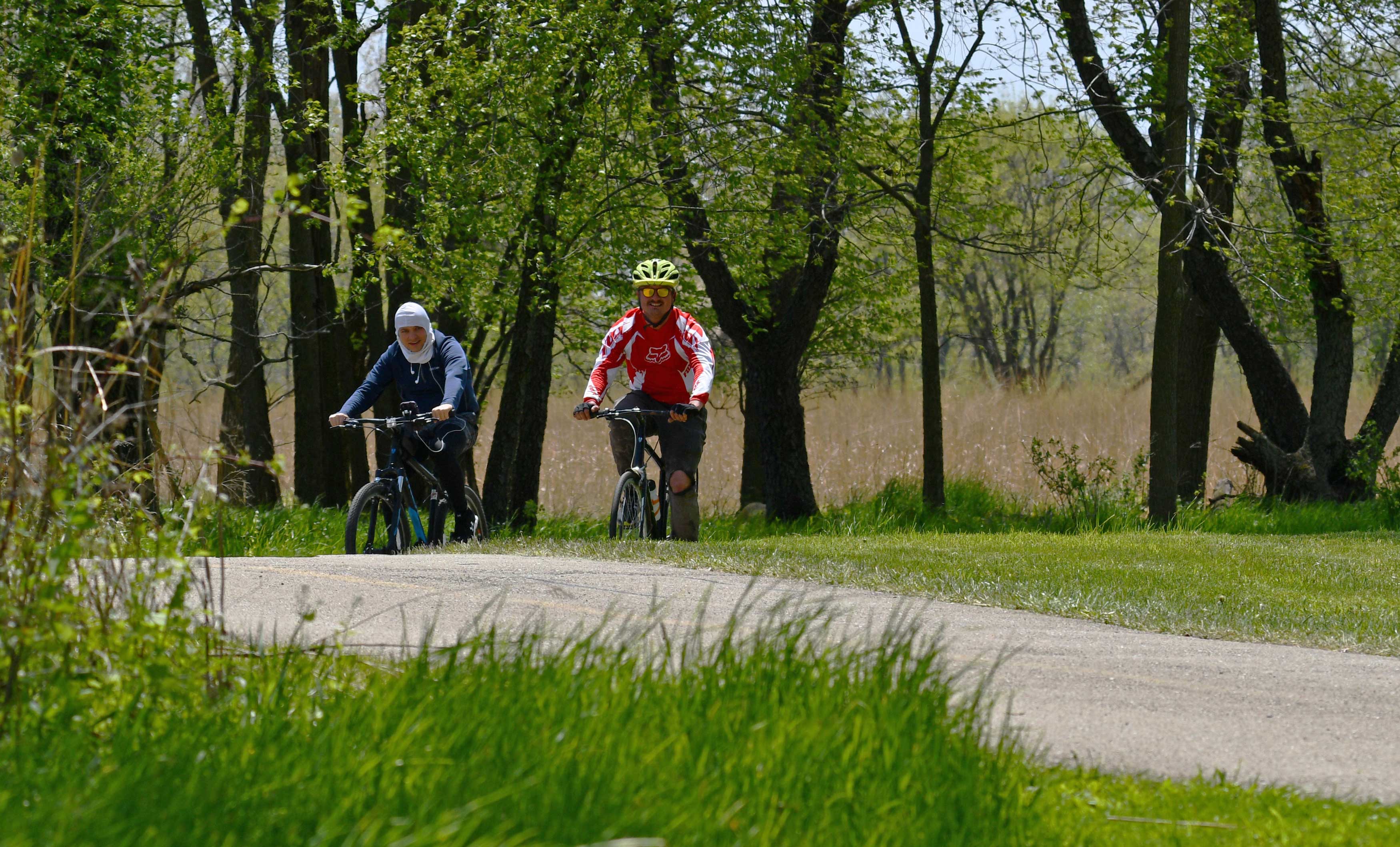 Two bicyclists on a trail.