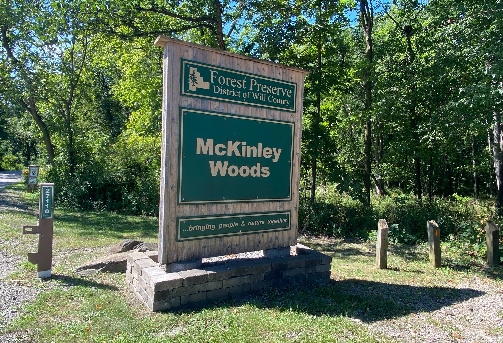 The large entrance sign indicating people are entering McKinley Woods. 