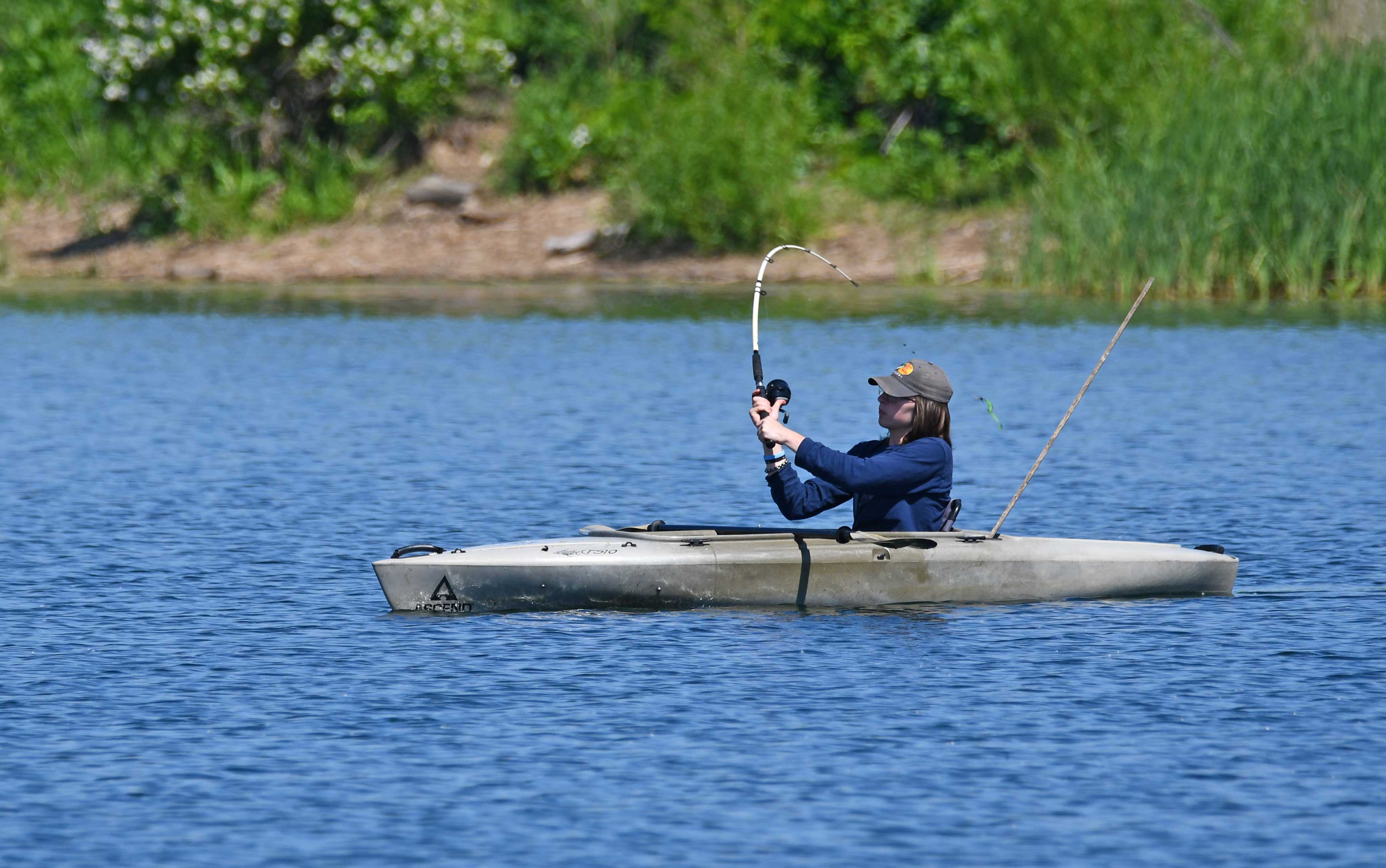 A person fishes from a kayak.