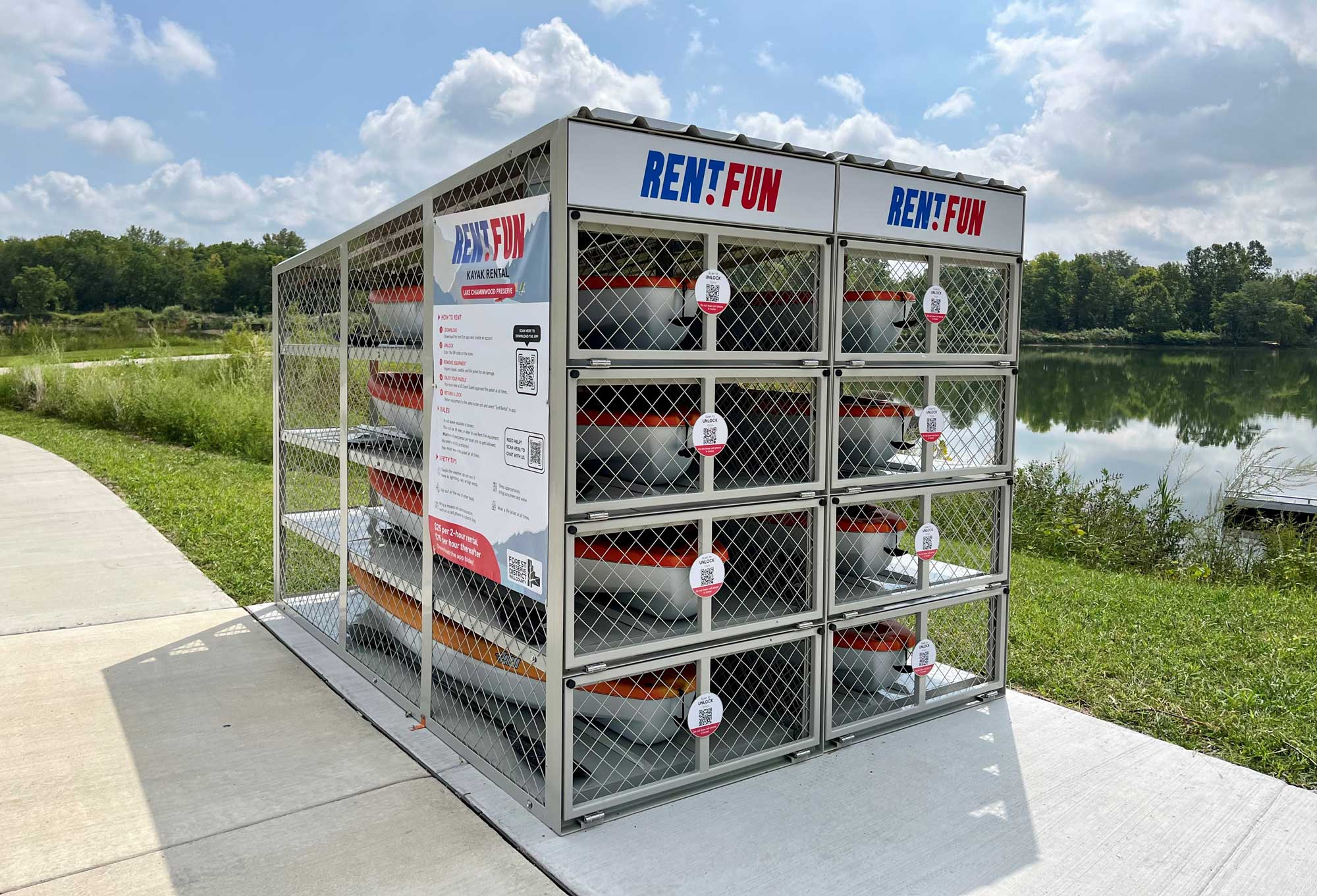 A view of kayak rental lockers next to a lake. 