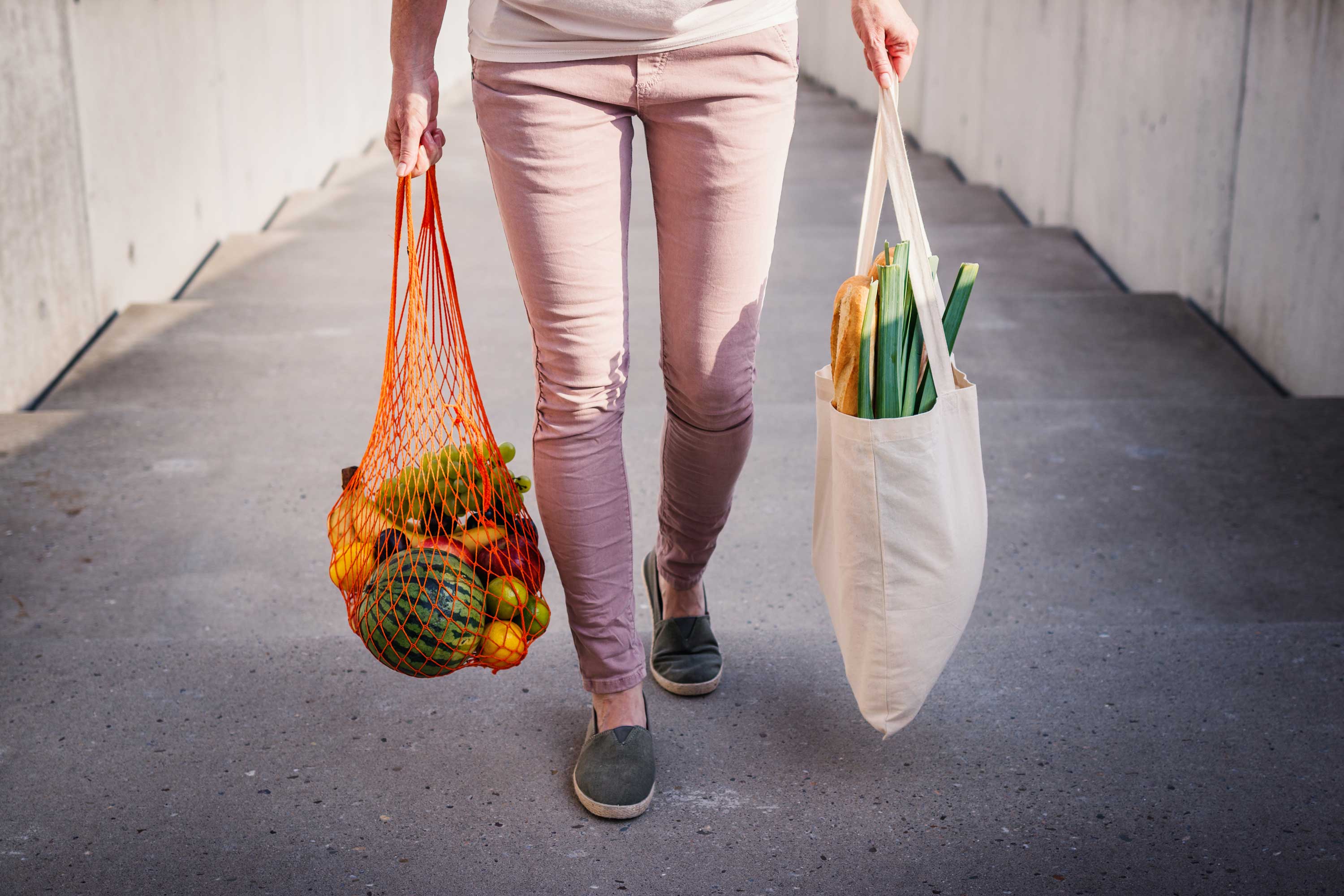 A person carrying reusable bags. 