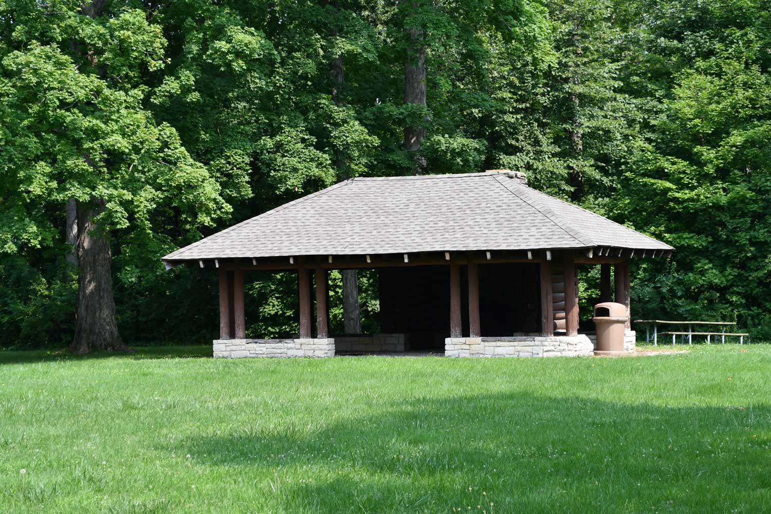 Picnic shelter with trees in background.