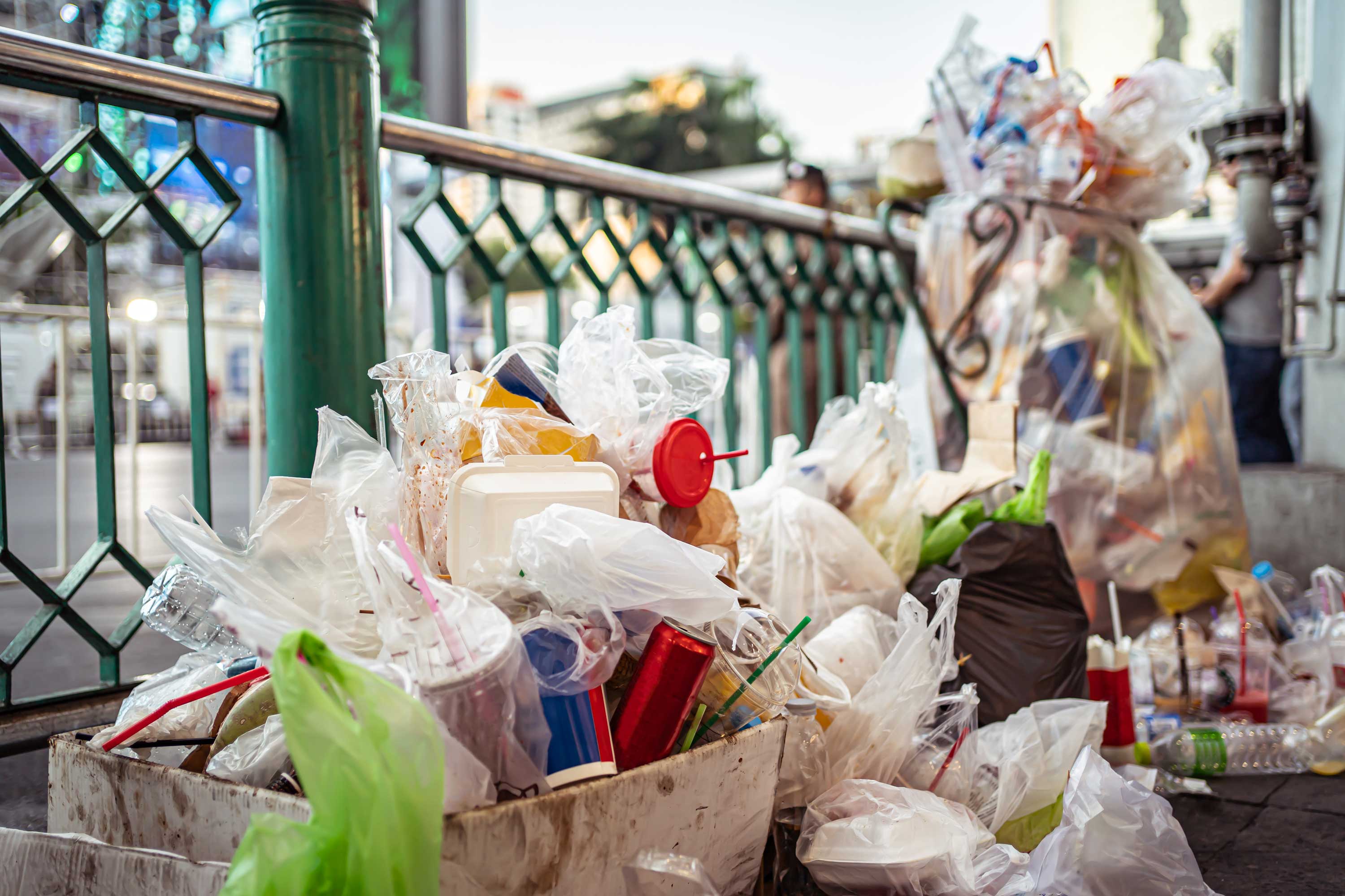 Trash filled with plastic items. 