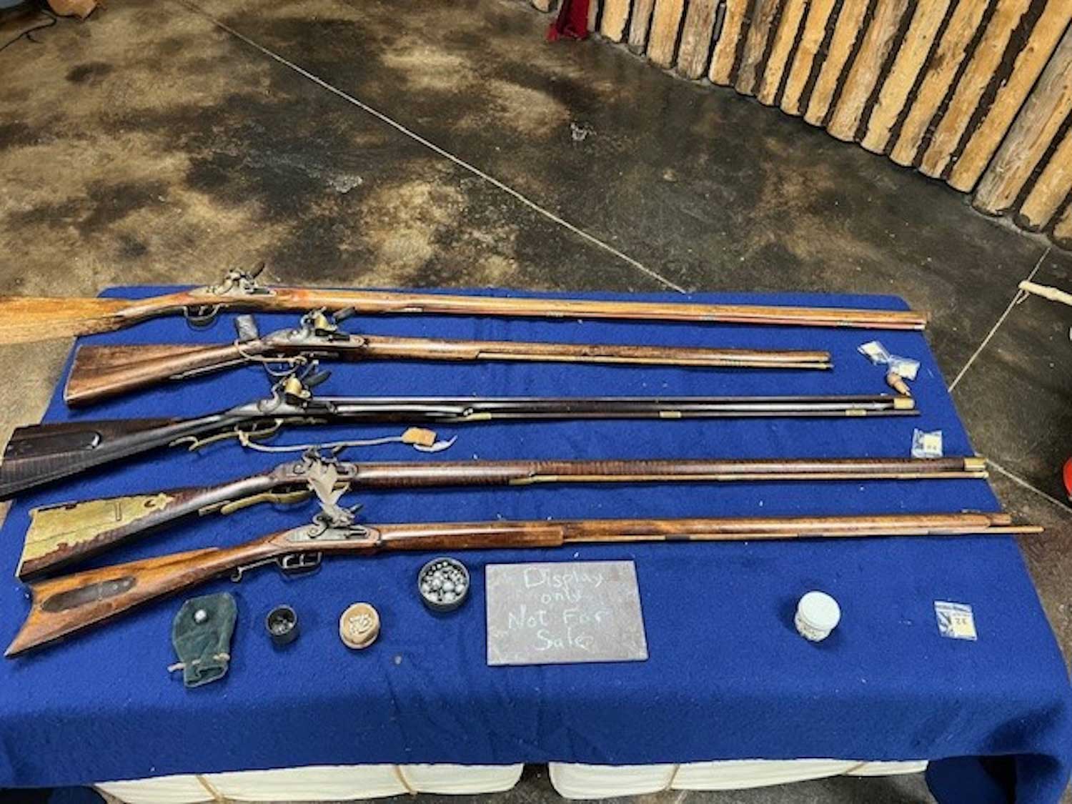 A collection of antique weapons laid out on a table.