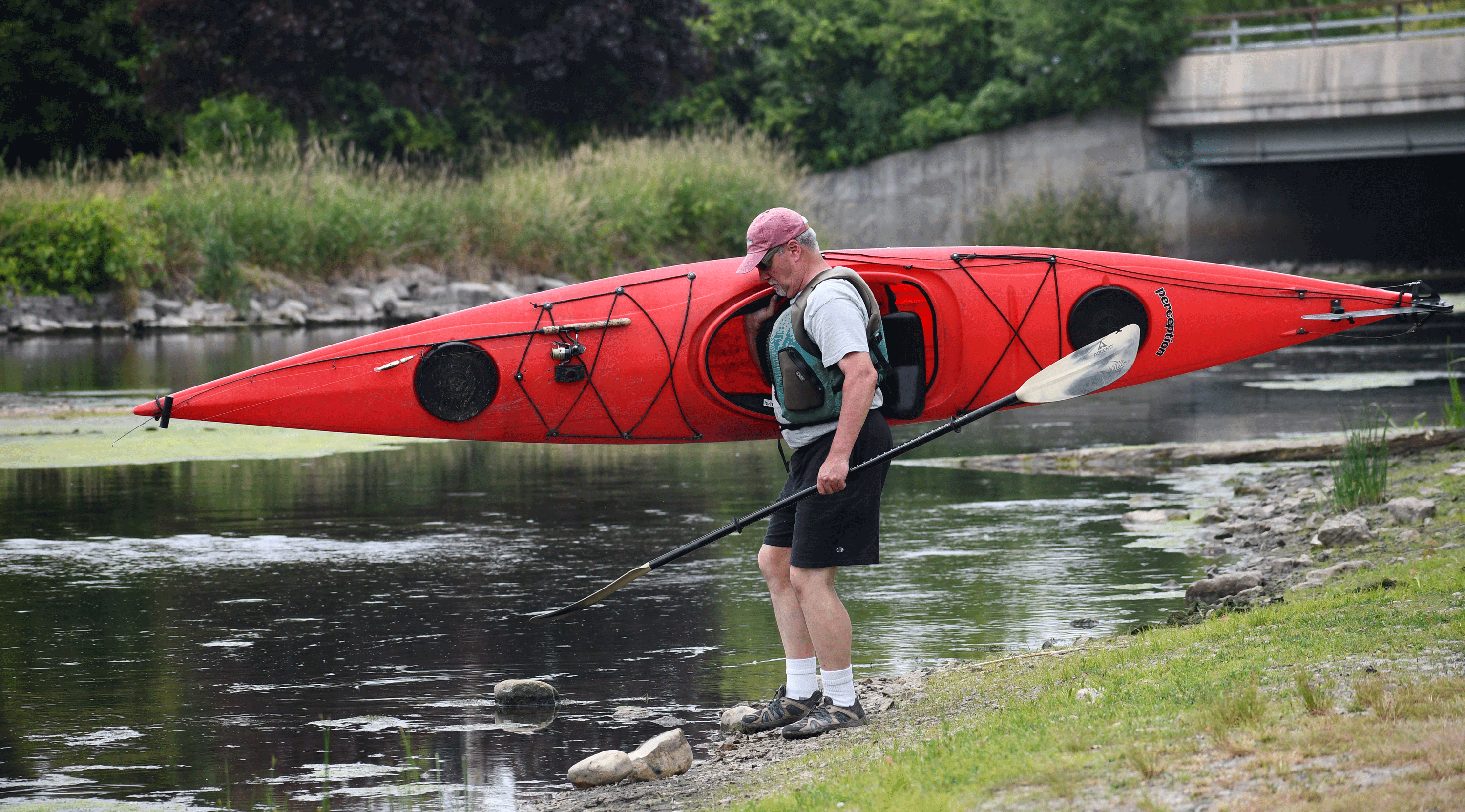 A preserve visitor carrying a kayak.