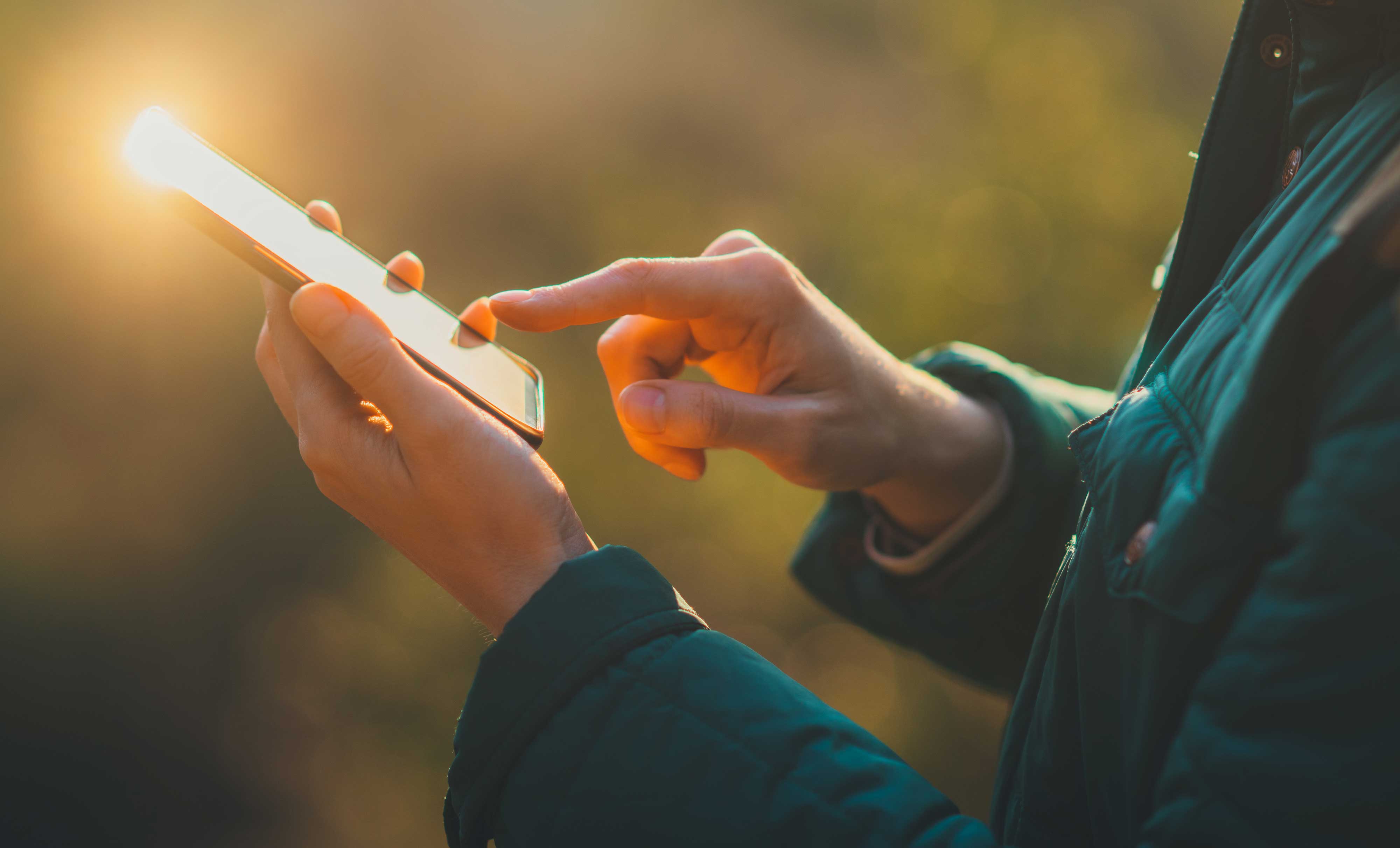 Closeup of a person using their cell phone.