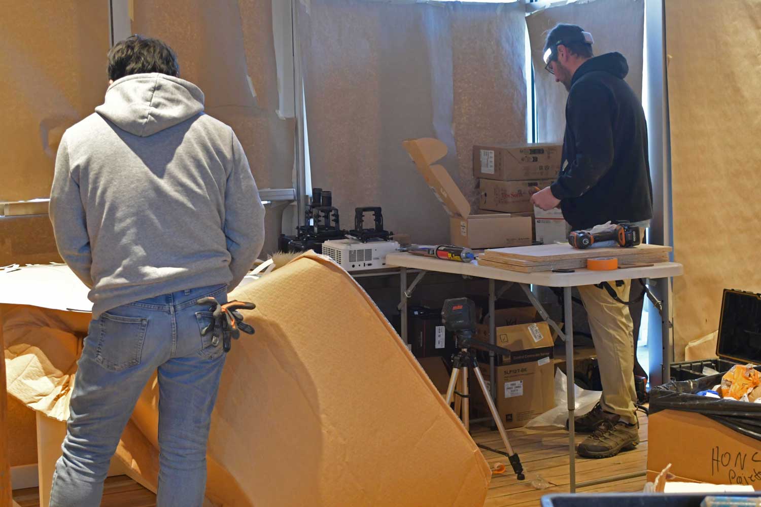 Two workers completing projects in a nature center.