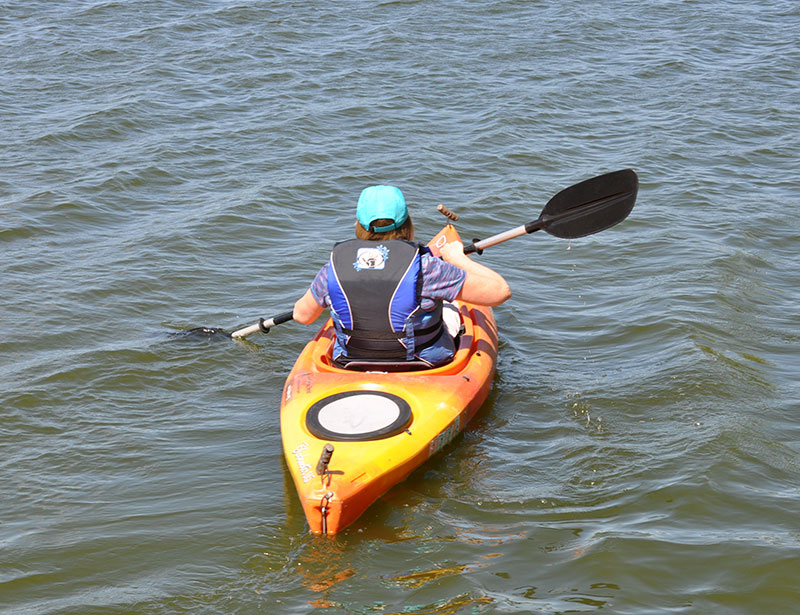 A person paddling a kayak through the water.