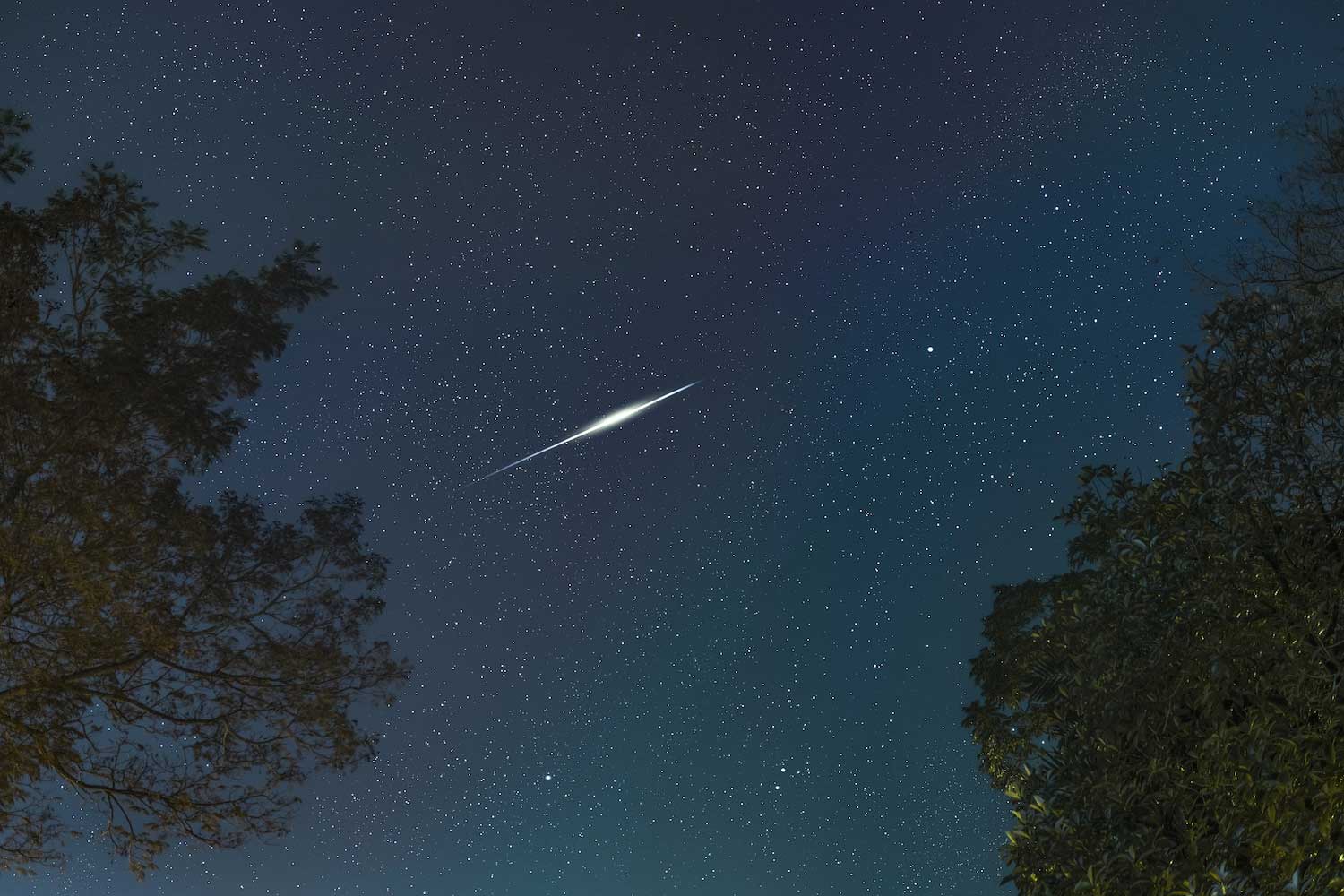 A shooting star streaking across the night sky.