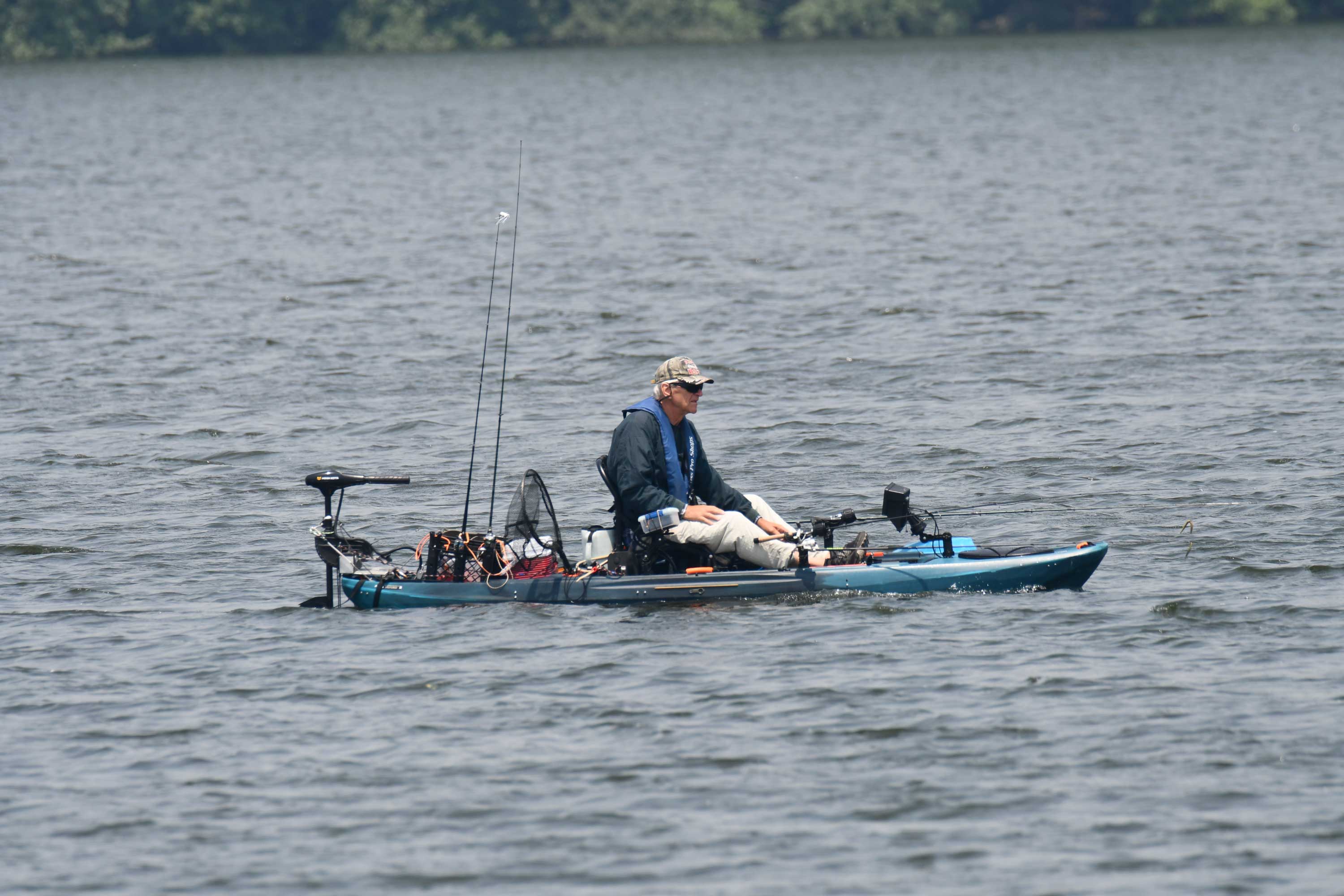 A person fishing in a kayak.