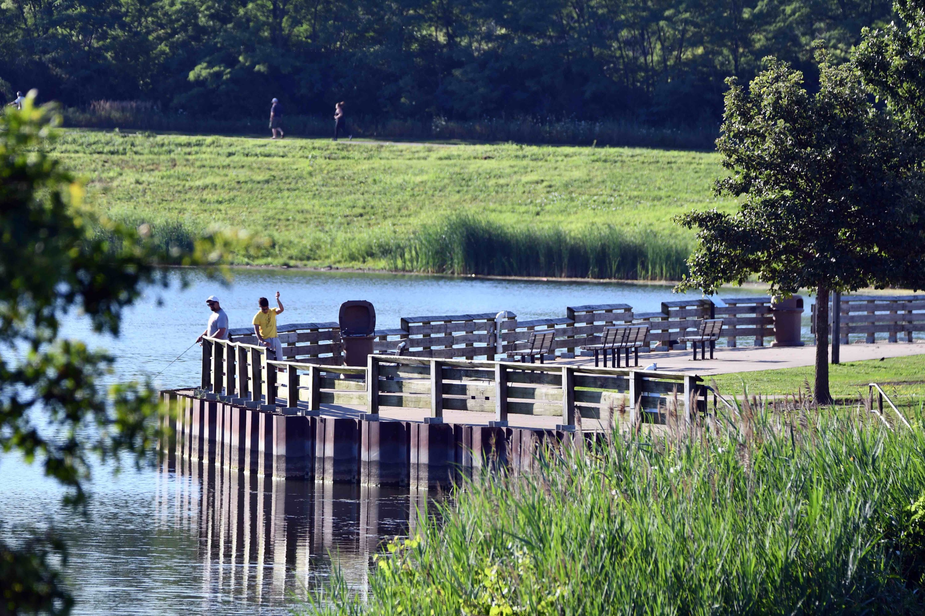 Two preserve visitors fishing.