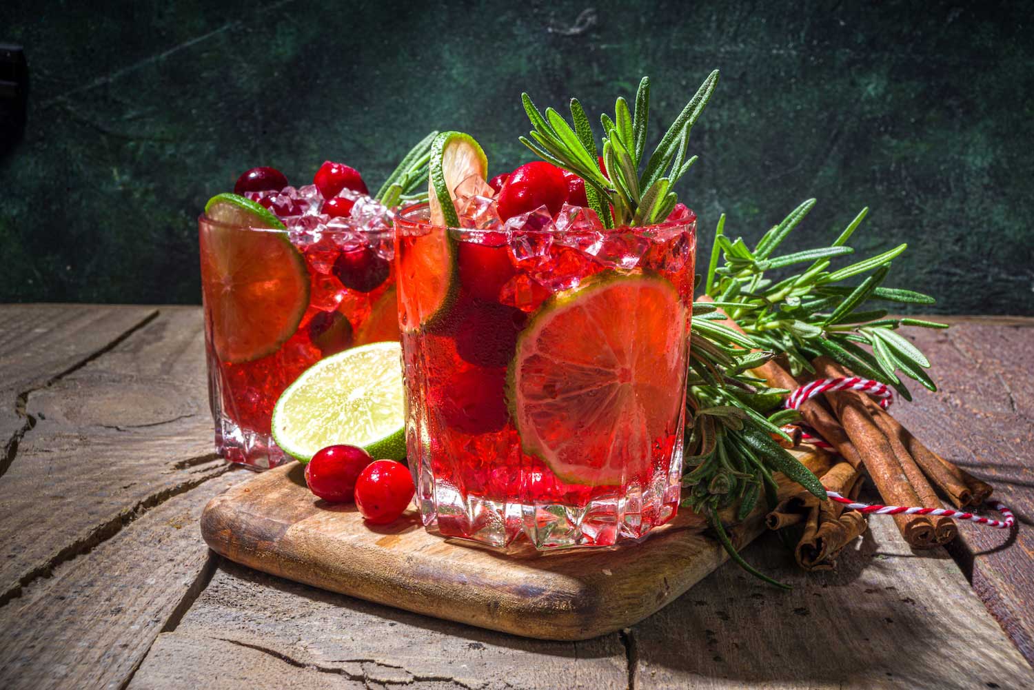 A two pinkish-red cocktails nicely displayed on a wooden table.