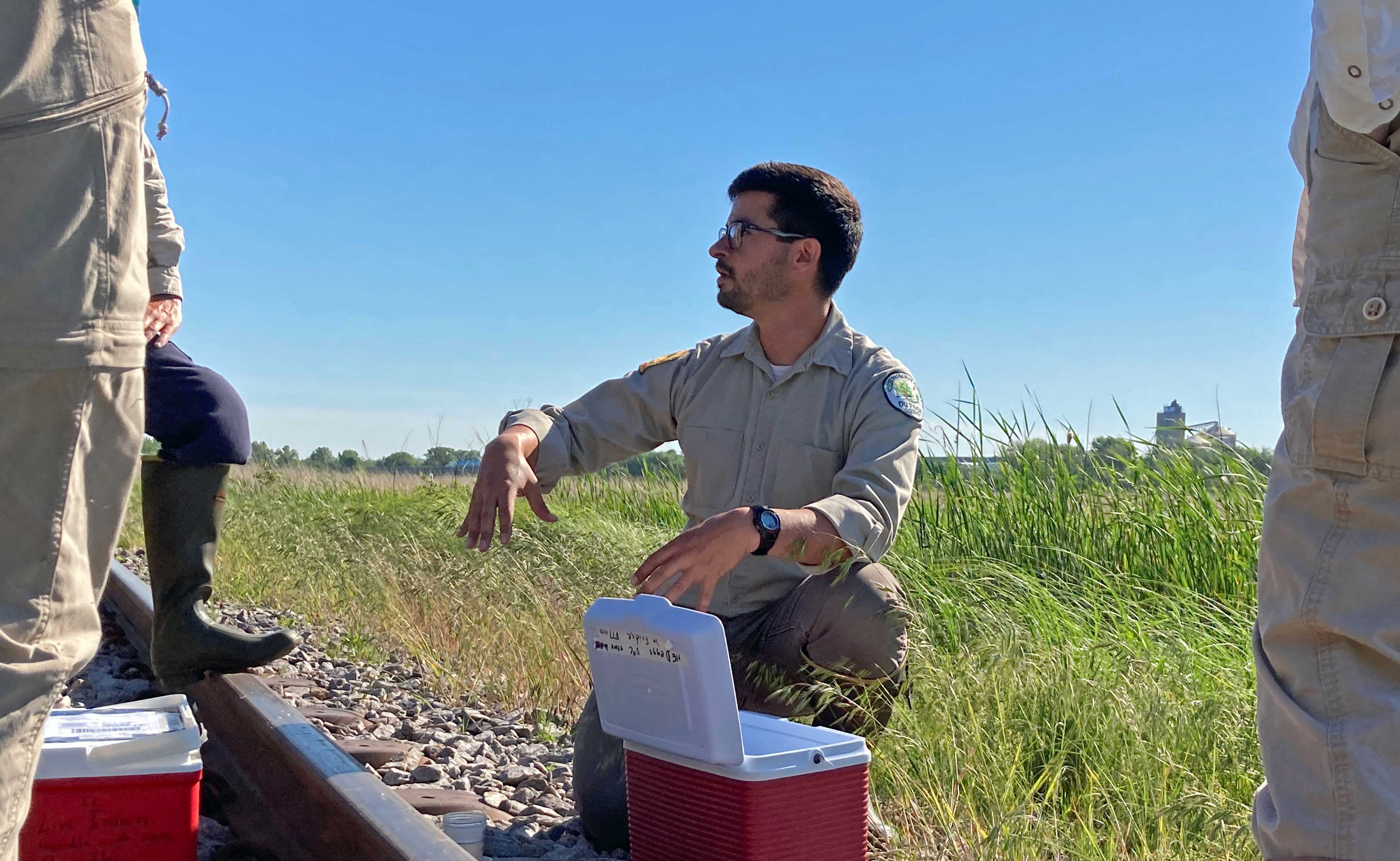 Andres Ortega, an ecologist with the Forest Preserve District of DuPage County, explains why Lockport Prairie Nature Preserve is a perfect spot to release the larvae.